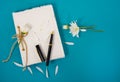 Daisy on journal with pen Royalty Free Stock Photo