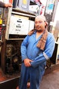 Dakhla Oasis, Egypt - April 3rd of 2015: A local employee poses in front of an old gas vending machine