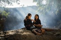 Daklak, Vietnam - Mar 9, 2017: Two Ede ethnic minority little girls learning to play the flute in forest. The Ede have long lived