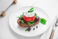 Dakos barley rusk with mizitra cheese, tomato, olives, oregano and olive oil. Cretan appetizer