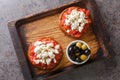 Dakos consists of a slice of cracked barley bread and garnished with crushed or grated ripe tomato and crumbled feta with oregano