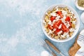 Dakos or koukouvagia salad. Classic recipe Cretan barley rusk salad with fresh tomato, mizithra cheese and oregano