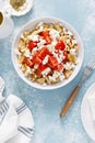 Dakos or koukouvagia salad. Classic recipe Cretan barley rusk salad with fresh tomato, mizithra cheese and oregano