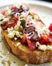 Dakos salad traditional Greek salad with soaked and crunchy barley rusks or bread, topped with juicy tomatoes, feta