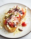 Dakos salad traditional Greek salad with soaked and crunchy barley rusks or bread, topped with juicy tomatoes, feta