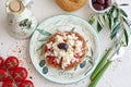 Dakos traditional Greekappetizer on a traditional plate with ceramic olive oil jar, dry rye bread, olives and olive branch. Health