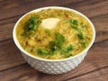 Dal khichdi or Khichadi, Tasty Indian recipe served in bowl over rustic wooden background, The food made of dal and rice combined