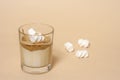 Dalgon coffee in a transparent glass with milk on a pastel background with marshmallows