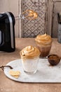 Dalgona coffee with regular and chocolate milk in a glass Royalty Free Stock Photo