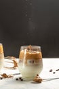 Dalgona coffee or whipped instant Korean coffee drink instant coffee or espresso powder whipped. pouring coffee in a frozen motion