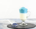 Dalgona Matcha Blue Latte, a creamy whipped matcha, on light background