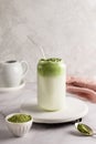 Dalgona matcha latte in glass, whipped grean tea with milk