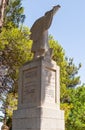 Large stone statue of Elijah - the Prophet stands on a stone pedestal in the garden of the Deir Al-Mukhraqa Carmelite Monastery in