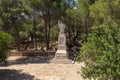 Large stone statue of Elijah - the Prophet stands on a stone pedestal in the garden of the Deir Al-Mukhraqa Carmelite Monastery in