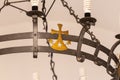 The religious bronze decoration on an iron chandelier hanging in interior of the Deir Al-Mukhraqa Carmelite Monastery building in