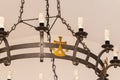 The religious bronze decoration on an iron chandelier hanging in interior of the Deir Al-Mukhraqa Carmelite Monastery building in