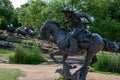 Dallas, Texas - May 7, 2018: Cowboy and longhorn cows with cattle in the background, as part of a landmark bronze cattle