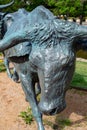 Dallas, Texas - May 7, 2018: Cowboy and longhorn cows with cattle in the background, as part of a landmark bronze cattle