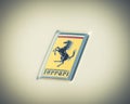 Vintage tone Ferrari logo on the luxury white supercar