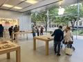 Customer shopping for latest model of iPhone, iPad, MacBook computer near large glass entrance of Appel Store in downtown Dallas,