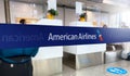 Blue barrier tape with the American Airlines logo inside an airport
