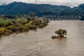 Dam across river with surging water and flooding