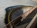 Dam architecture. Concrete lake weir with non-freezing water Royalty Free Stock Photo