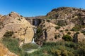 The dam of the lake of Elche with a waterfall on a summer day. Royalty Free Stock Photo