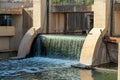 Dam in an industiral part of the city with round pillars and water fall for water contamination cleaning and purification Royalty Free Stock Photo