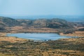 A dam/lake at the foot of the hills, in Pilansberg Nature Reserve in South Africa