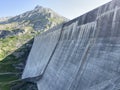 The dam Lucendro or concrete dam on the reservoir lake Lago di Lucendro in the Swiss alpine area of the St. Gotthard Pass