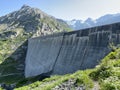 The dam Lucendro or concrete dam on the reservoir lake Lago di Lucendro in the Swiss alpine area of the St. Gotthard Pass