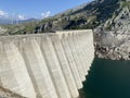 The dam Lucendro or concrete dam on the reservoir lake Lago di Lucendro in the Swiss alpine area of the St. Gotthard Pass