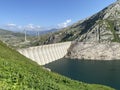 The dam Lucendro or concrete dam on the reservoir lake Lago di Lucendro in the Swiss alpine area of the St. Gotthard Pass