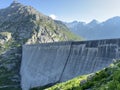 The dam Lucendro or concrete dam on the reservoir lake Lago di Lucendro in the Swiss alpine area of the St. Gotthard Pass