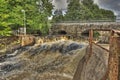 Dam and old stone bridge of the hydroelectric power station in HDR Royalty Free Stock Photo