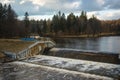 A dam on a small river and a pond with wooded island near Moscow
