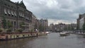 A canal cruiser with tourists sailing on the Rokin canal