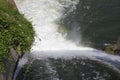 Dam wall and overflow of Iskar Dam. Water flowing over a dam wall. Mist rising above the Iskar dam wall. Cascade from a hydroelect Royalty Free Stock Photo