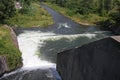 Dam wall and overflow of Iskar Dam. Water flowing over a dam wall. Mist rising above the Iskar dam wall. Cascade from a hydroelect Royalty Free Stock Photo