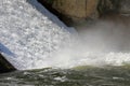 Dam wall and overflow of Iskar Dam. Water flowing over a dam wall. Mist rising above the Iskar dam wall. Cascade from a hydroelect Royalty Free Stock Photo