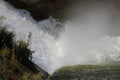 Dam wall and overflow of Iskar Dam. Water flowing over a dam wall. Mist rising above the Iskar dam wall. Cascade from a hydroelect Royalty Free Stock Photo