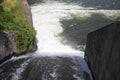 Dam wall and overflow of Iskar Dam. Water flowing over a dam wall. Mist rising above the Iskar dam wall. Cascade from a hydroelect Royalty Free Stock Photo