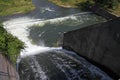 Dam wall and overflow of Iskar Dam. Water flowing over a dam wall. Mist rising above the Iskar dam wall. Cascade from a hydroelect Royalty Free Stock Photo