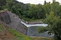 Dam wall and overflow of Iskar Dam. Water flowing over a dam wall. Mist rising above the Iskar dam wall. Cascade from a hydroelect Royalty Free Stock Photo