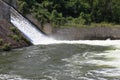 Dam wall and overflow of Iskar Dam. Water flowing over a dam wall. Mist rising above the Iskar dam wall. Cascade from a hydroelect Royalty Free Stock Photo