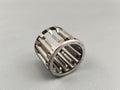 Damage a needle roller bearing is seen on a gray surface. Royalty Free Stock Photo