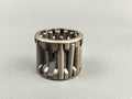 Damage a needle roller bearing is seen on a gray surface. Royalty Free Stock Photo