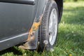 Damage to the car body, corrosion and rust of the front fender from the outside. Holes and metal destruction, selective focus