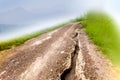 Damage unpaved roads, gravel roads, laterite roads on A Foggy Day beside the hill. Royalty Free Stock Photo